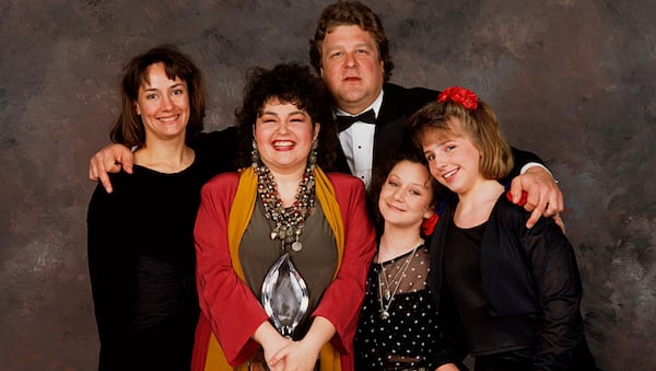 BEVERLY HILLS, CA - 1989:  The cast of Roseanne, (l-r) Laurie Metcalf, Roseanne Barr, John Goodman, Sara Gilbert and Lecy Goranson, pose backstage after winning the 1989 People's Choice Award for best TV Comedy in Beverly Hills, California.  (Photo by George Rose/Getty Images)