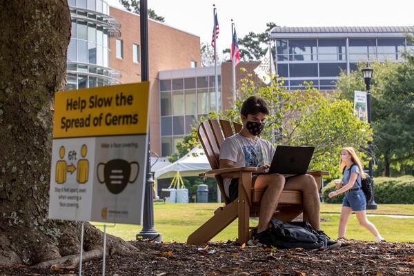 Kennesaw State University freshman Kyle Johnson wears a mask as he works on his computer during the first day of classes at Kennesaw State University's main campus in Kennesaw, Monday, Aug. 17, 2020. (Alyssa Pointer / Alyssa.Pointer@ajc.com)