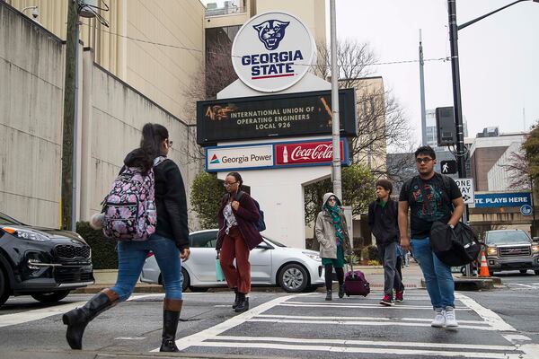 Students navigate Georgia State University's main campus in Atlanta, Tuesday, March 10, 2020. Georgia State University students are urging the campus to follow the example of dozens of colleges around the country and move to online classes in the face of the mounting  coronavirus threat. A petition for online classes collected more than 11,000 signatures overnight, helped along by a news story about the effort in the Signal, the GSU student newspaper.  