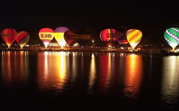 Balloons illuminate the lake at night at the Sky High Hot Air Balloon Festival.