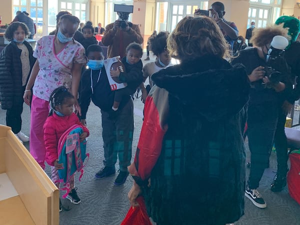 Roberta Shields from The Ludacris Foundation hands out toys to the children of families impacted by the fire.