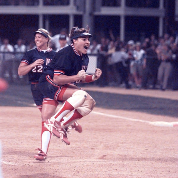 American softball pitcher Lisa Fernandez (right) leaps for joy after the U.S. women's softball team won the gold medal in the competition Tuesday, July 30, 1996, during the 1996 Summer Olympic Games in Columbus. (Marlene Karas/AJC)