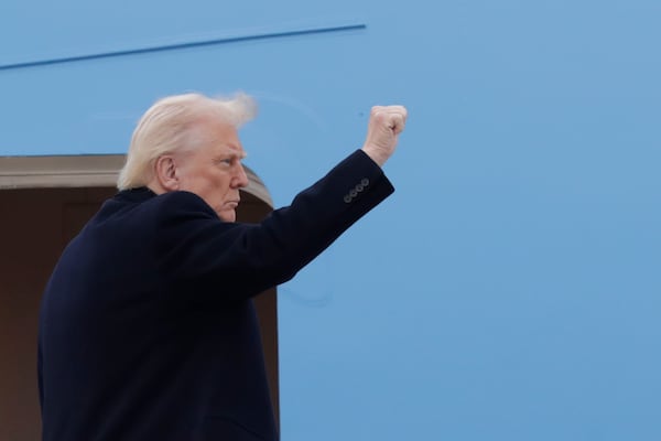 President Donald Trump gestures from the stairs of Air Force One at Joint Base Andrews, Md., Friday, March 14, 2025, (AP Photo/Luis M. Alvarez)