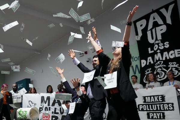 FILE - Activists participate in a demonstration for climate finance at the COP29 U.N. Climate Summit, Nov. 21, 2024, in Baku, Azerbaijan. (AP Photo/Sergei Grits, File)