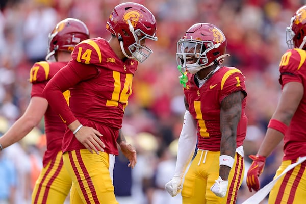 Southern California wide receiver Zachariah Branch (1) celebrates with quarterback Jayden Maiava (14) after his touchdown during the first half of an NCAA football game against Notre Dame, Saturday, Nov. 30, 2024, in Los Angeles. (AP Photo/Ryan Sun)