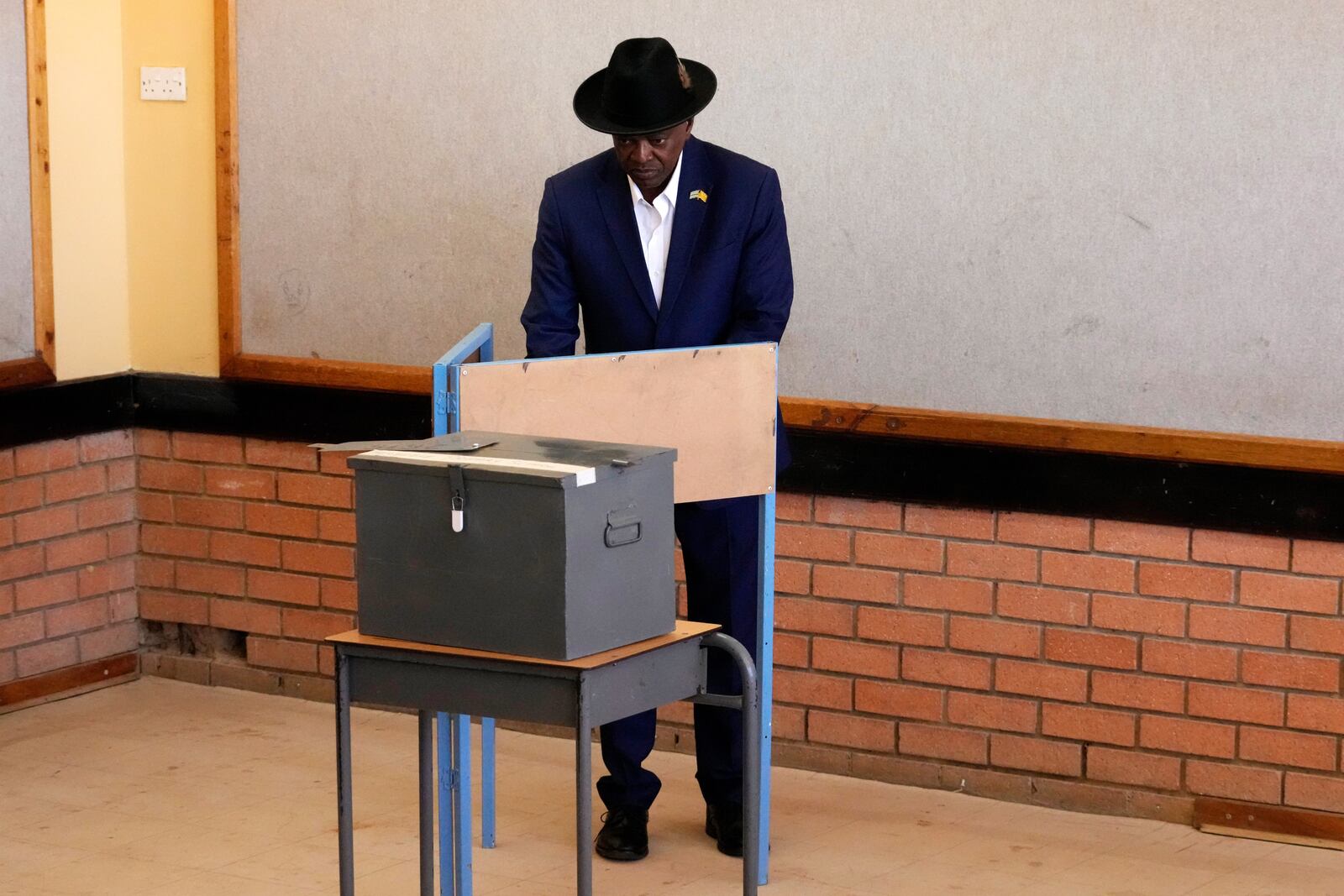 Botswana Democratic Party President Mokgweetsi Masisi stands on a voting booth before casting his vote during an election to decide if it keeps faith with one of the Africa's longest-ruling parties, at a Mosielele primary school in Moshupa village, southern District of Botswana, Wednesday, Oct. 30, 2024. (AP Photo/Themba Hadebe)