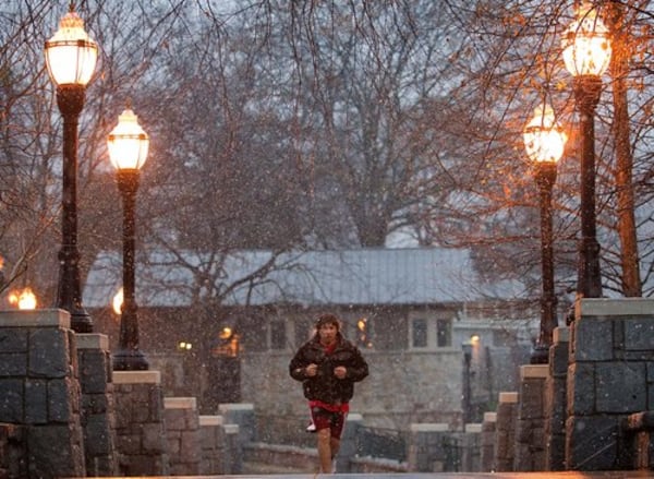 Sahin Tetik, of Atlanta, jogs as snow falls in Atlanta's Piedmont Park Saturday, Dec. 25, 2010. Snow, sleet and icy rain began falling Saturday morning in some parts of north Georgia, and the wintry mix descended on metro Atlanta in the afternoon.