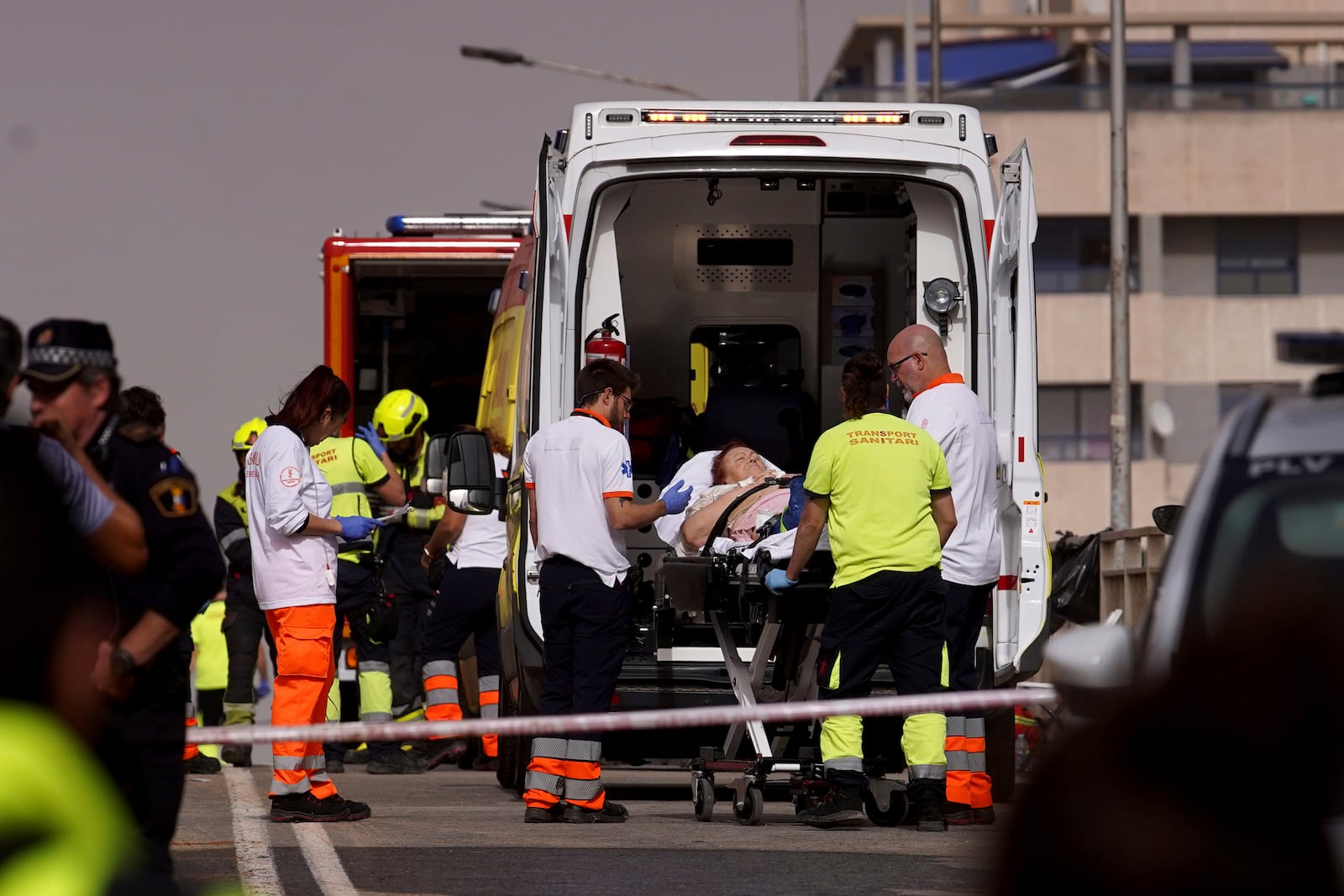 A woman is taken away in an ambulance after being rescued from the floods in Valencia, Spain, Wednesday, Oct. 30, 2024. (AP Photo/Alberto Saiz)