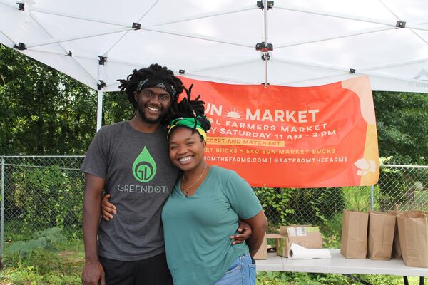 Gabbie Atsepoyi and partner Brenton Hill smile last summer at Sun Market, the Decatur farmers market Atsepoyi created in April 2021. A small grant from the nonprofit Georgia Organics helped advertise Sun Market, which Atsepoyi said she hopes to turn into her community’s “non-stop shop for local and organic grown produce.” (Courtesy of Suzanne Girdner)