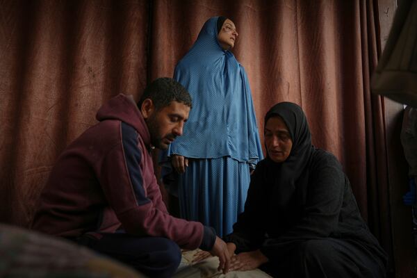 Members of the Al-Kahlout family mourn over the bodies of their relatives killed during an Israeli army strike before their burial at the Baptist hospital in Gaza City, Monday, March 24, 2025.(AP Photo/Jehad Alshrafi)