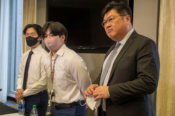 09/16/2021 — Atlanta, Georgia — Brothers Eric Park, left, and Randy Park, center, stand with their lawyer, Jason park, right, and answer questions from the press following the announcement of the AAPI Crime Victims and Education Fund at Alston and Bird Law in Atlanta’s Midtown community, Thursday, September 16, 2021. Eric and Randy’s mother, Hyun Jung Grant, was one of the victims of the Spa Shootings that took place six months ago in Atlanta. (Alyssa Pointer/Atlanta Journal Constitution)