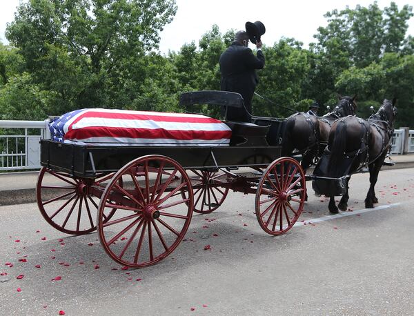 The body of Rep. John Lewis makes the final crossing over the Edmund Pettus Bridge in July in Selma, Alabama. The congressman from Georgia and civil rights icon died July 17 at age 80 after a battle with pancreatic cancer. Curtis Compton ccompton@ajc.com