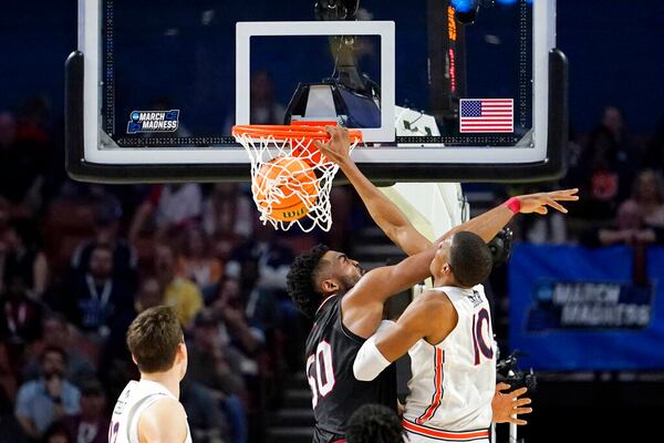 Auburn's Jabari Smith, right, dunks over Jacksonville State's Brandon Huffman during the second half of a college basketball game in the first round of the NCAA tournament Friday, March 18, 2022, in Greenville, S.C. (AP Photo/Brynn Anderson)