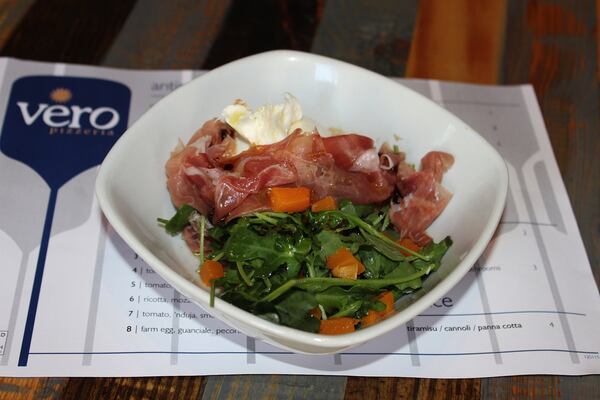 Burrata with prosciutto and charred winter squash salad.