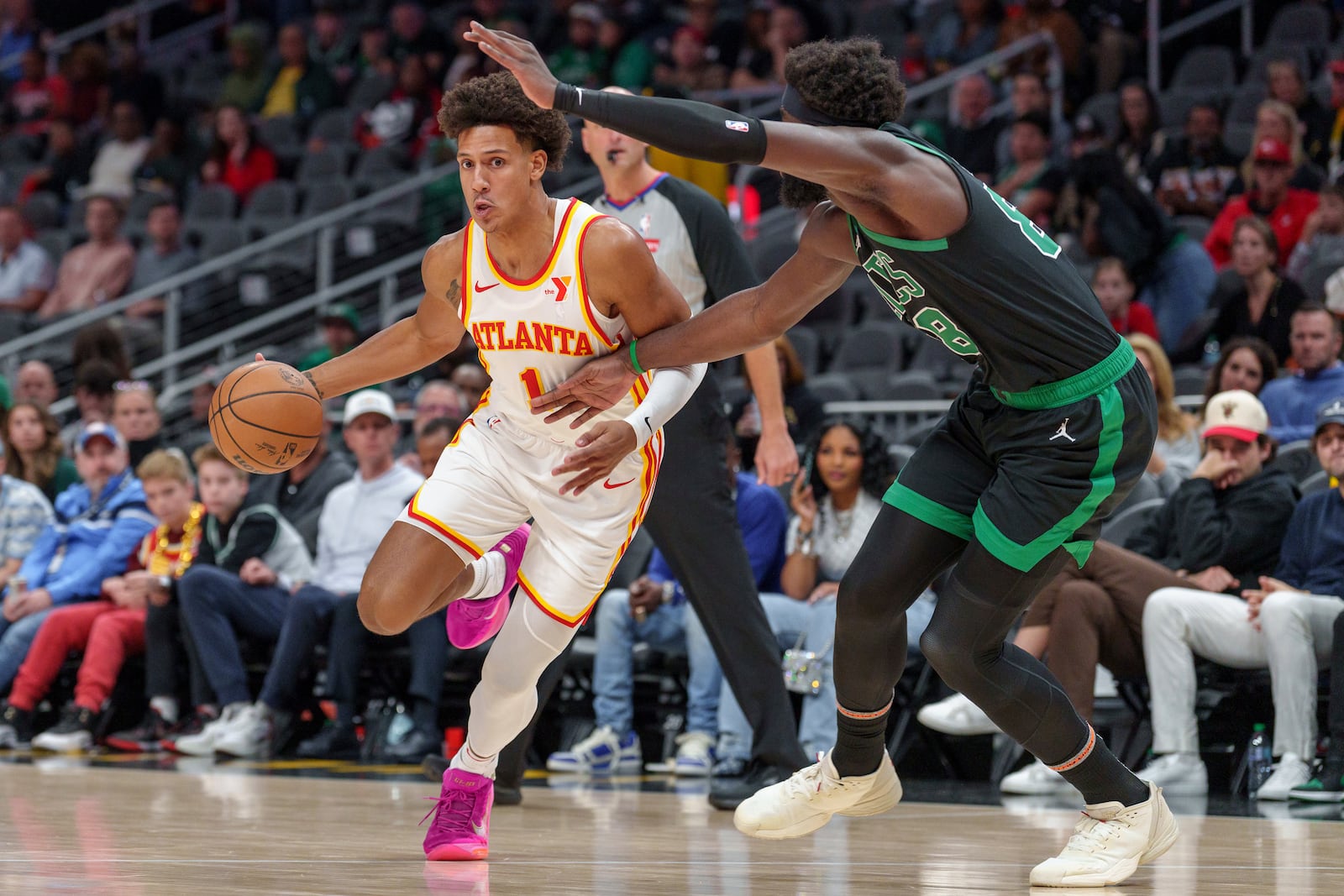 Atlanta Hawks forward Jalen Johnson (1) dribbles while guarded by Boston Celtics center Neemias Queta (88) during the first half of an NBA basketball game, Monday, Nov. 4, 2024, in Atlanta. (AP Photo/Jason Allen)