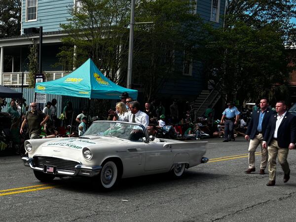 Gov. Brian Kemp and first lady Marty Kemp rode in the back of a white convertible during the parade honoring St. Patrick in Savannah on Saturday.