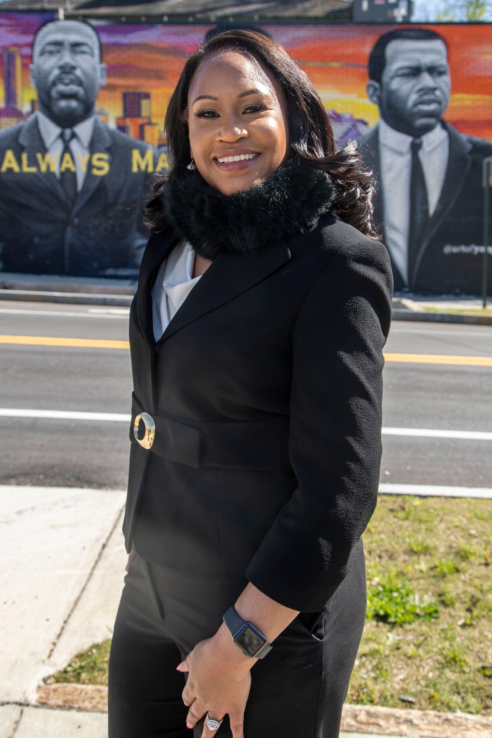 Coretta Whipple, who was named after Coretta Scott King, poses in front of a mural down the street from King's old Vine City in Atlanta. “I have never tried to dishonor her name in any way,” Whipple said. (Alyssa Pointer / Alyssa.Pointer@ajc.com)