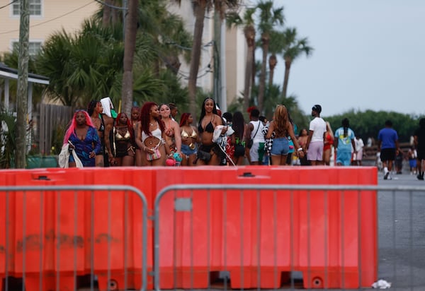 Attendees of Orange Crush in Tybee Island walk toward Butler Ave. after exiting the beach on Saturday, April 20, 2024. (Natrice Miller/AJC)