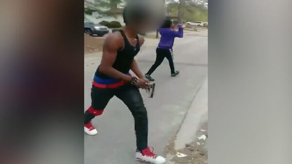 Authorities are searching for a teenager they say aimed a gun at a girl in an attempt to break up a fight.