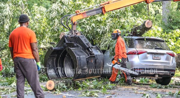 Crews cleared debris and restored power after a tree fell on two vehicles and took out power lines Wednesday morning on Clairemont Avenue.