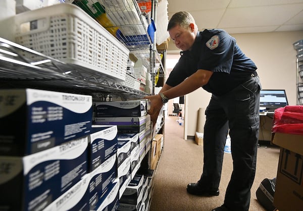 Paul Beamon, vice president of emergency medical services at AmeriPro EMS, unpacks supplies bought from local stores at AmeriPro EMS in Riverdale on Wednesday, March 18, 2020.  As a greater sense of desperation takes hold, some medical professionals are using creative ways to find supplies, including purchasing masks from painting companies and going to Home Depot. (Hyosub Shin / Hyosub.Shin@ajc.com)