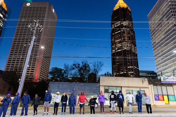 Runners with Back on My Feet Atlanta stretch after an early  morning run in Atlanta on Wednesday, November 16, 2022. The nonprofit helps people who are homeless and struggling with addiction build confidence, accountability and other life skills through running. (Arvin Temkar / arvin.temkar@ajc.com)