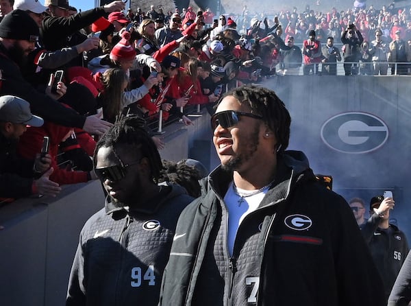 Georgia offensive lineman Devin Willock (77) enters the stadium Saturday during the Bulldogs' celebration in Athens. Willock and football staff member Chandler LeCroy died in a car accident early Sunday. Two other members of the football program also were injured and are in stable condition. (Hyosub Shin / Hyosub.Shin@ajc.com)