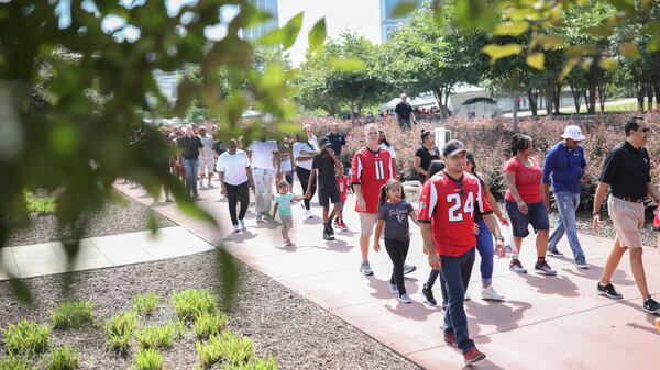 Fans make their way to Mercedes-Benz Stadium Sunday, July 29, 2018,  for the Falcons open practice in Atlanta.