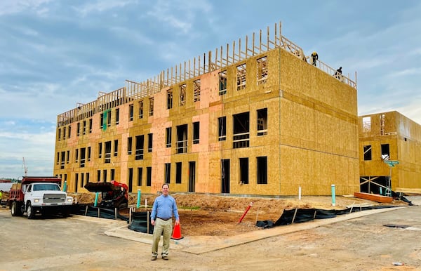 Steve Brock, founder of Brock Built Homes, stands in front of new townhomes that have crossed the $500,000 price tag on Donald Lee Hollowell Parkway. Photo by Bill Torpy