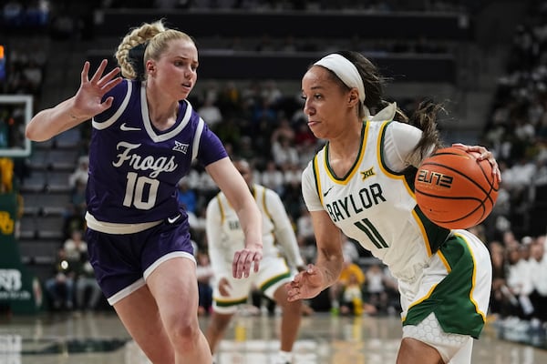 Baylor guard Jada Walker (11) drives to the basket as TCU guard Hailey Van Lith (10) defends in the first half of an NCAA college basketball game in Waco, Texas, Sunday, March 2, 2025. (AP Photo/Tony Gutierrez)