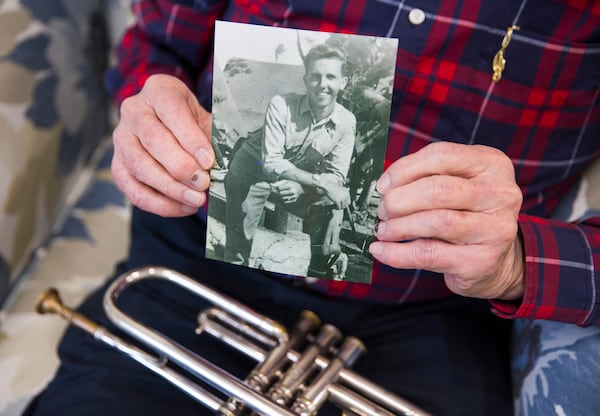 Gould displays a photo of himself when he was in the Marines. He has seen the world turned over both by the Nazis and 9/11. “When you live a long time, you learn to keep it simple.” Ashley Landis/Dallas Morning News/TNS