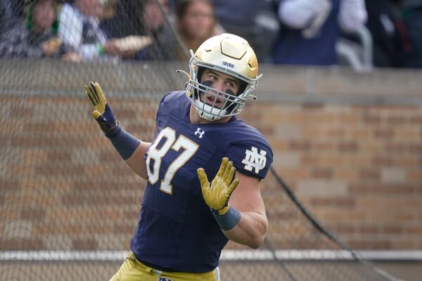 Notre Dame's Michael Mayer (87) reacts following a touchdown reception during the first half of an NCAA college football game against Georgia Tech, Saturday, Nov. 20, 2021, in South Bend, Ind. (AP Photo/Darron Cummings)