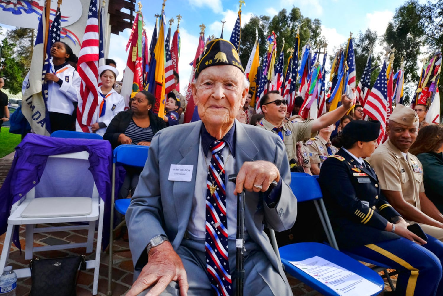 scouts place flags at veteran graves to honor memorial day