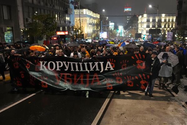 People march during a protest following the collapse of a concrete canopy at the railway station in Novi Sad that killed 14 people, in Belgrade, Serbia, Monday, Nov. 11, 2024. (AP Photo/Darko Vojinovic)