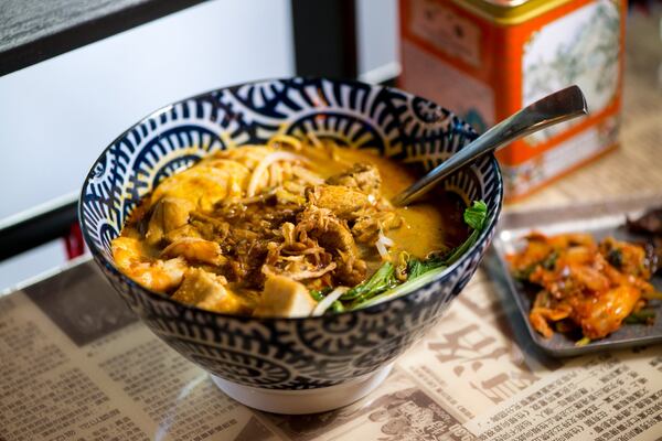 Hawkers Curry Laska Noodle Soup with coconut curry stew, shrimp, chicken, fried tofu, wheat noodles, bean sprouts, yow choy, fried shallots, and hard boiled egg. Photo credit- Mia Yakel.