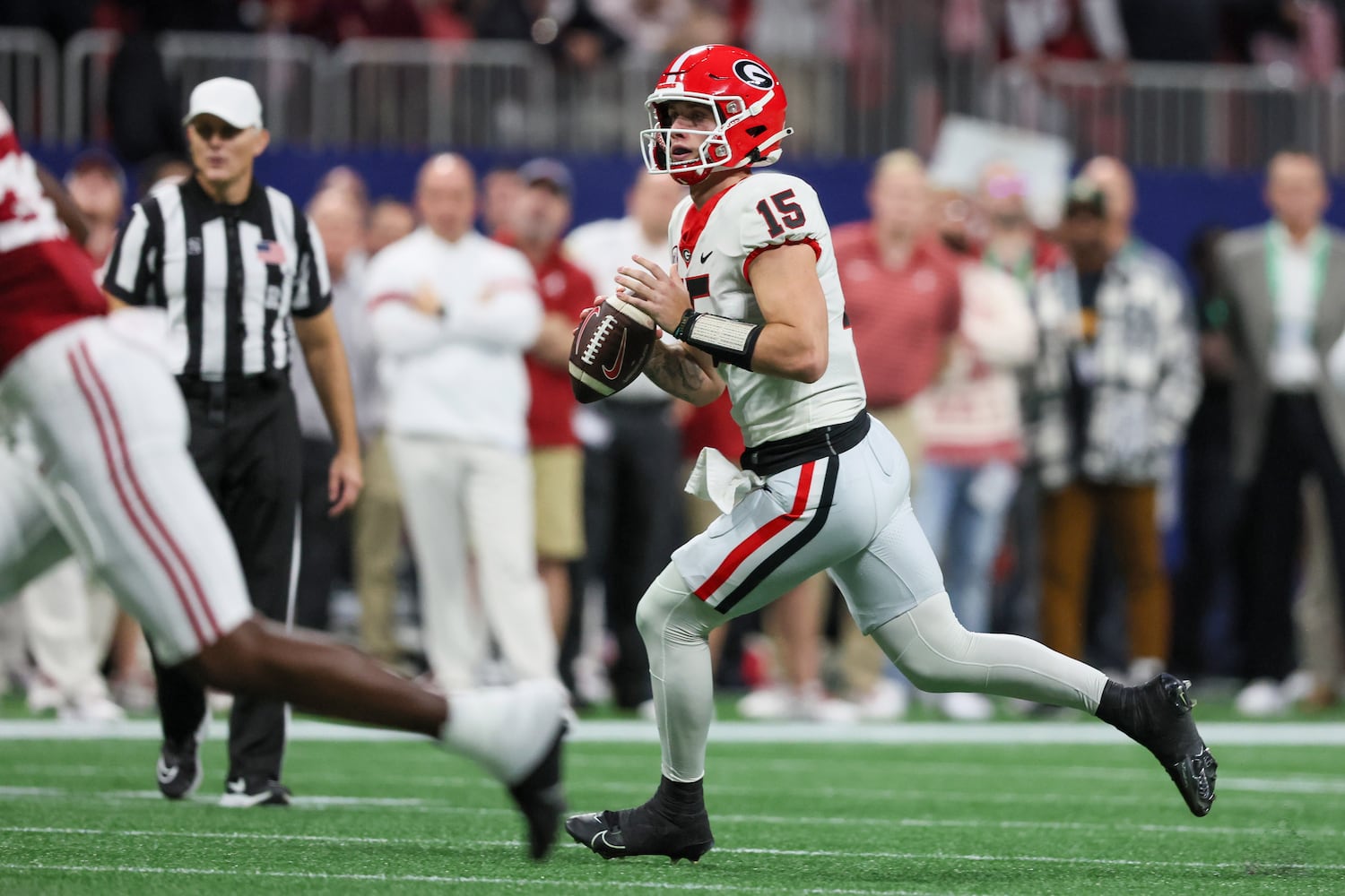 Georgia Bulldogs quarterback Carson Beck (15) scrambles against the Alabama Crimson Tide during the first half of the SEC Championship football game at the Mercedes-Benz Stadium in Atlanta, on Saturday, December 2, 2023. (Jason Getz / Jason.Getz@ajc.com)