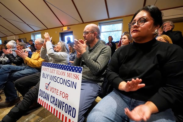 People applaud during a town hall meeting at the George Culver Community Library Thursday, March 6, 2025, in Sauk City, Wis. (AP Photo/Morry Gash)