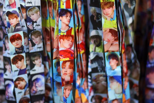 Fans love to collect K-pop merchandise like these neck lanyards at the KPOP Store in USA. (Jason Getz / Jason.Getz@ajc.com)