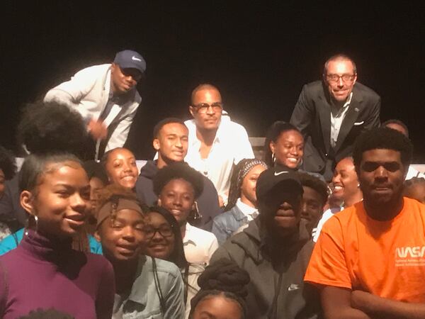 T.I., dressed in a white shirt, poses with Atlanta Public Schools students after a discussion at Georgia Tech. ERIC STIRGUS / ESTIRGUS@AJC.COM.