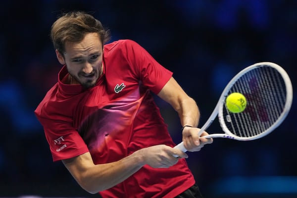 Russia's Daniil Medvedev returns the ball to Italy's Jannik Sinner during their singles tennis match of the ATP World Tour Finals at the Inalpi Arena, in Turin, Italy, Thursday, Nov. 14, 2024. (AP Photo/Antonio Calanni)