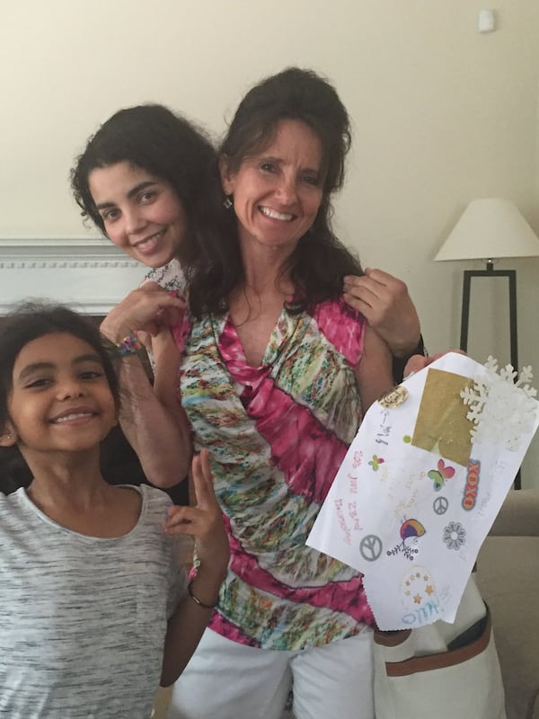 Sabra Cohen (right) is embraced by daughter Shairoz in 2016.