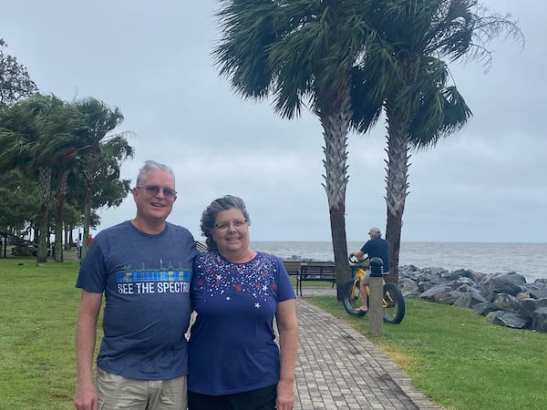 Rulong and Becky VanDyke of Suwanee walk along Neptune Park overlooking St. Simons Sound on Georgia's coast on Tuesday, Aug. 6, 2024. The couple arrived on the island Saturday for a weeklong family vacation.  Monday’s downpour was their first experience waiting out a tropical storm but it left them unfazed. “I closed my eyes and turned off the lights,” said Becky VanDyke.