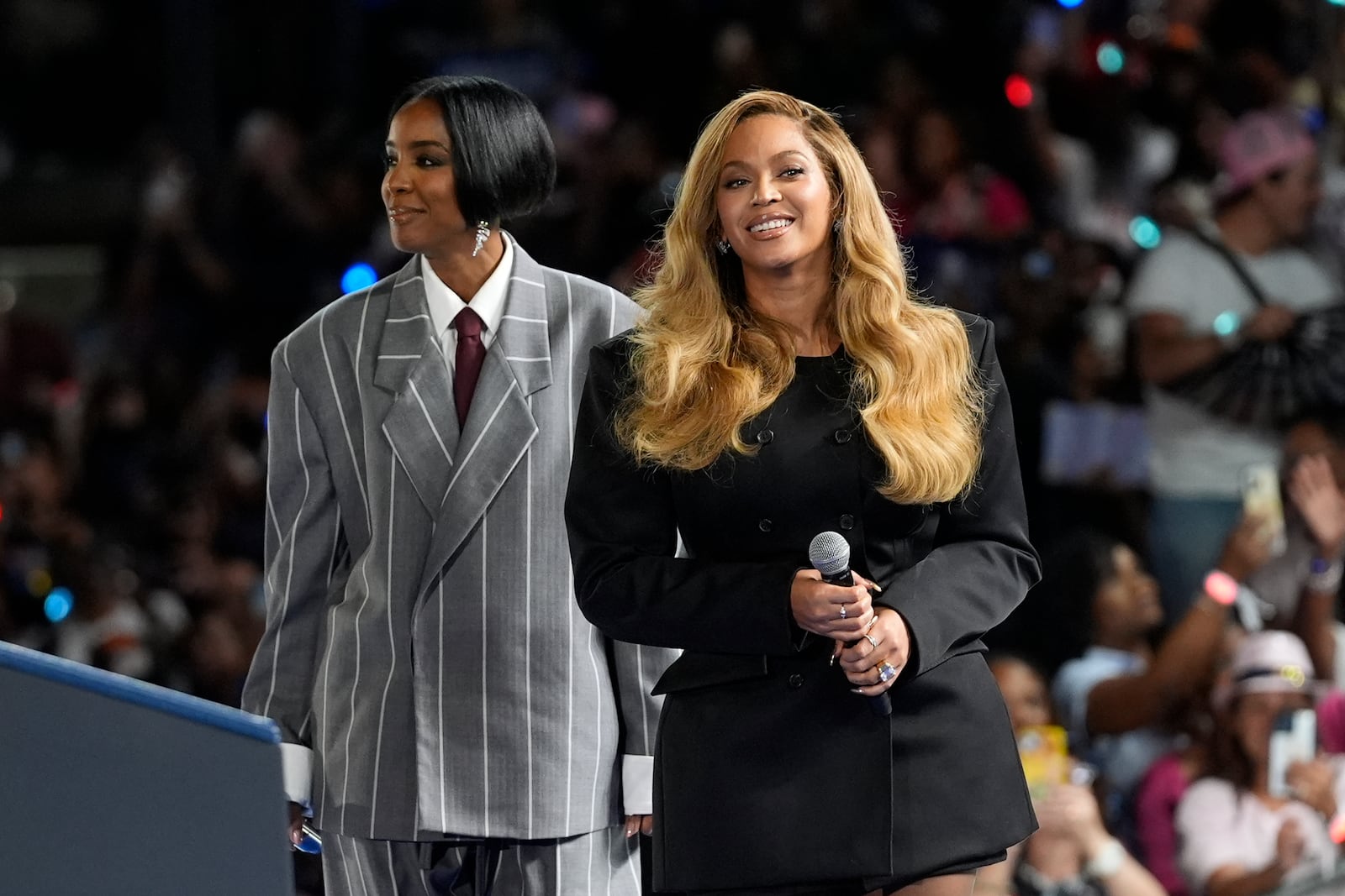 Musical artists Beyonce, right, and Kelly Rowland, left, on stage at a campaign event for Democratic presidential nominee Vice President Kamala Harris in Houston, Friday, Oct. 25, 2024. (AP Photo/Susan Walsh)