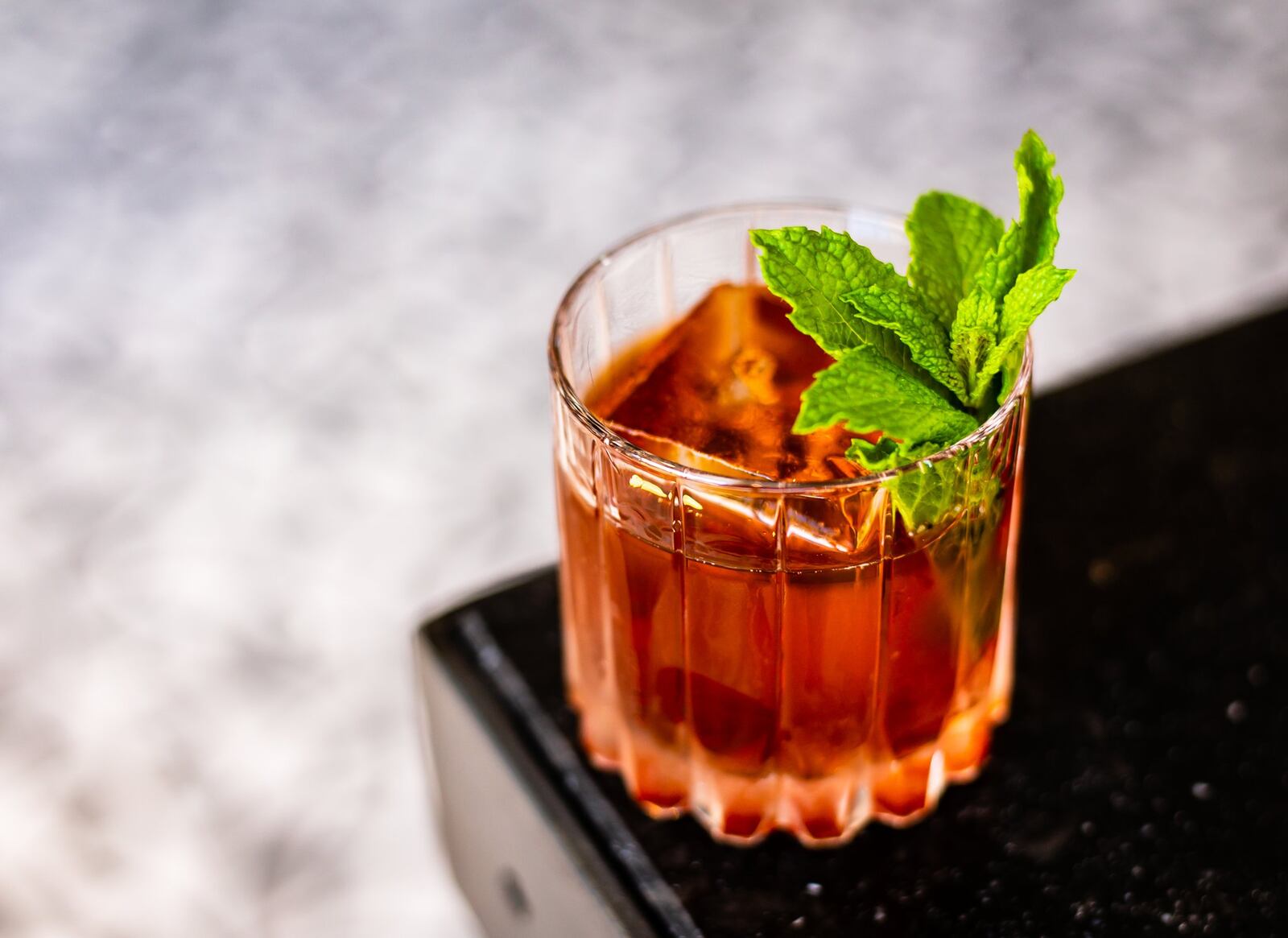 The Two World Hero cocktail at By George is a spin on a Vieux Carré featuring black tea-infused cognac. CONTRIBUTED BY HENRI HOLLIS