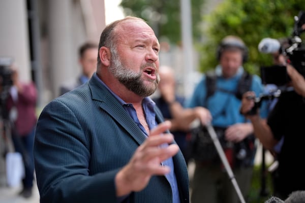 FILE - Right-wing conspiracy theorist Alex Jones speaks to the media after arriving at the federal courthouse for a hearing in front of a bankruptcy judge, Friday, June 14, 2024, in Houston. (AP Photo/David J. Phillip, File)