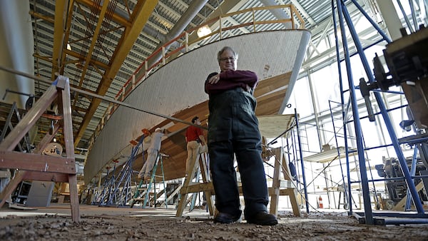 FILE - In this Dec. 18, 2013 file photo, Tom Czekanski, senior curator and restoration manager at the National World War II Museum, stands in front of one of the surviving World War II-era PT boats as it undergoes restoration in New Orleans. The PT-305, a U.S. Navy patrol torpedo boat that sank three vessels and saw action in Europe, is back in New Orleans where it was built and tested - what historians describe as the nation's only fully restored ship of that type that saw direct combat in World War II.  (AP Photo/Gerald Herbert, File)