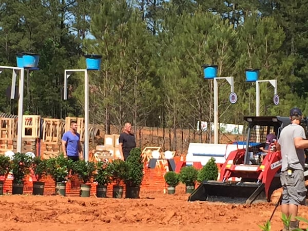 Tim Tebow and Mike Holmes on one of the big challenge courses the creators set up. CREDIT: Rodney Ho/ rho@ajc.com