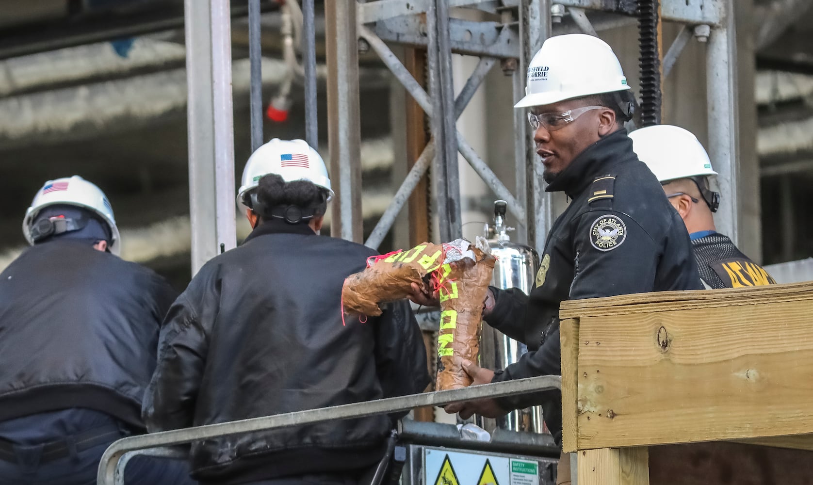 Two people locked themselves to construction equipment in Midtown to protest Atlanta’s planned public safety training center, causing a street to close amid the Monday morning commute, Jan. 29, 2024. The activists used reinforced bindings to lock their arms around the equipment at a Brasfield & Gorrie work site at 12th and Juniper streets. One person was locked to a construction elevator and the other to a boom. Both were released by 10:15 a.m. Juniper Street was closed to traffic for hours Monday morning before reopening around 11:30 a.m. SWAT team members were also at the scene for assistance in cutting the activists free. Brasfield & Gorrie is one of the contractors hired to build the training facility at the site of the old Atlanta Prison Farm in the south DeKalb County woods. Those opposed to the facility say its construction will damage the South River Forest and contribute to what they say is the militarization of the police department. (John Spink / John.Spink@ajc.com)

