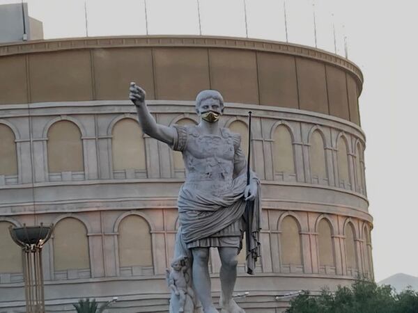 The front of Caesars Palace in Las Vegas reminds guests about face masks.