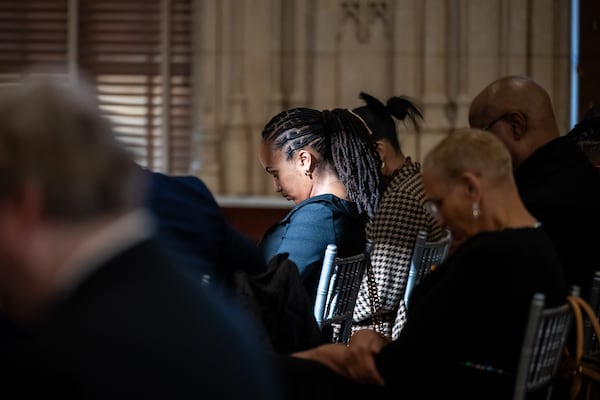 250103 ATLANTA, GA — Zoë Fort, daughter of Georgia State Sen. Vincent Fort, bows her head in prayer during a brief service as Sen. Fort lies in state in the old council chambers at Atlanta City Hall on Friday, Jan. 3, 2025. Fort died from complications from cancer in December at 68 years old.
(Bita Honarvar for The Atlanta Journal-Constitution)